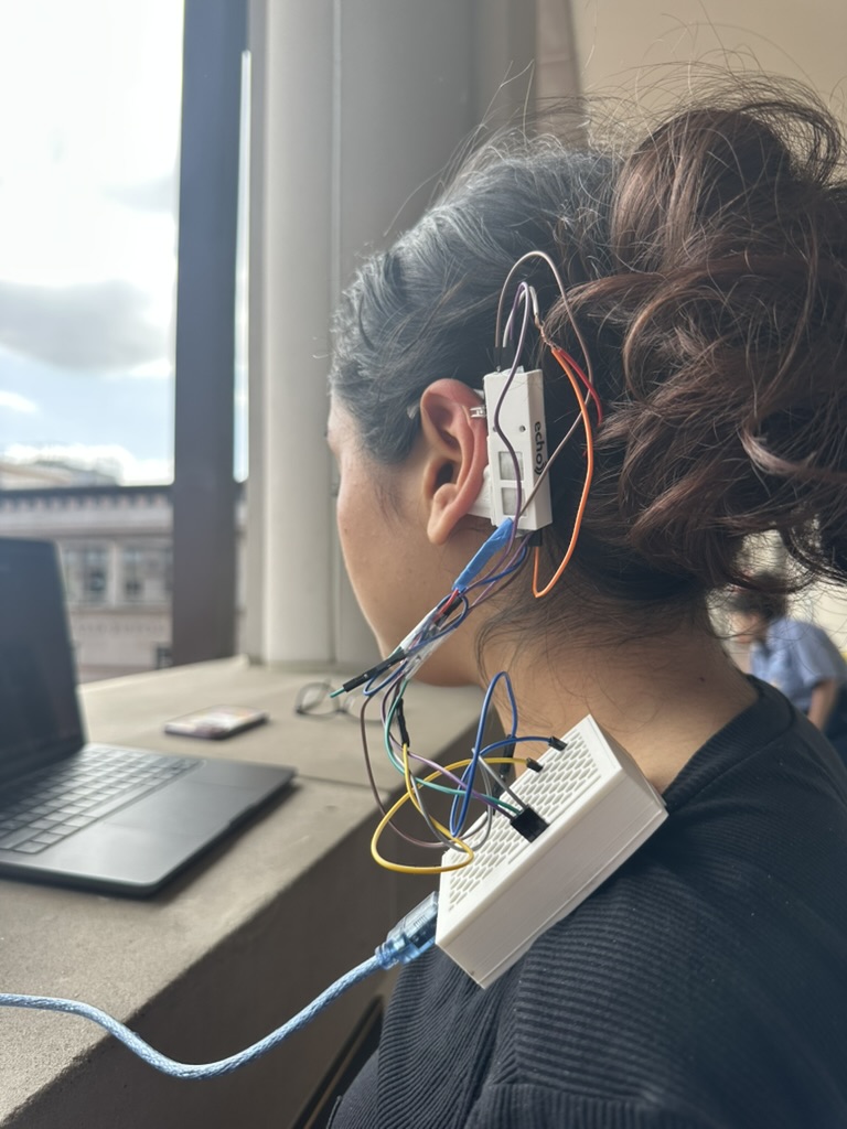 Halo wearable prototype attached behind a participant's ear