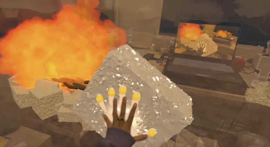 Molded By The Rock mixed-reality experience showing hand tracking near a virtual rock and fire
