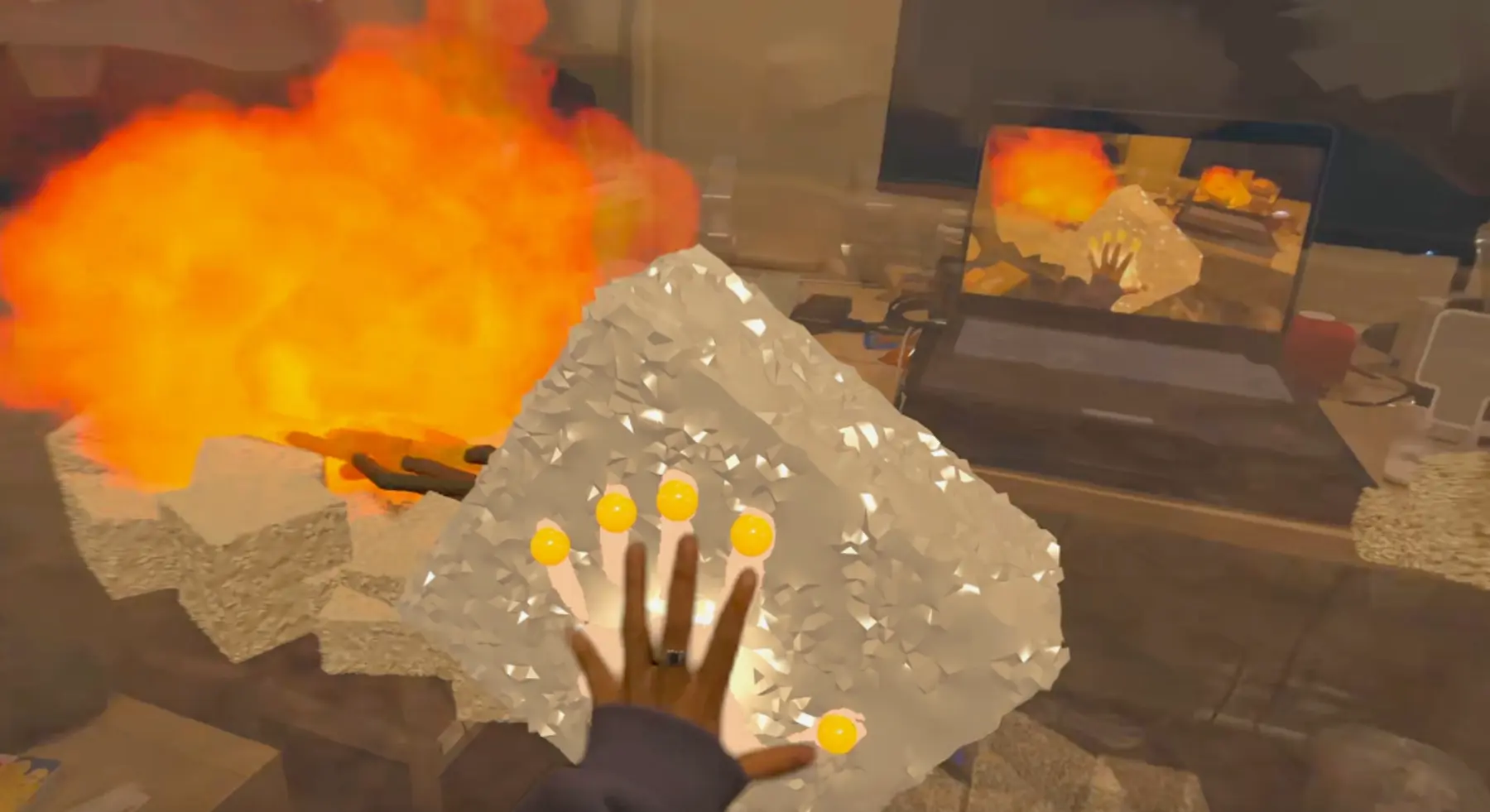 Molded By The Rock mixed-reality experience showing hand tracking near a virtual rock and fire